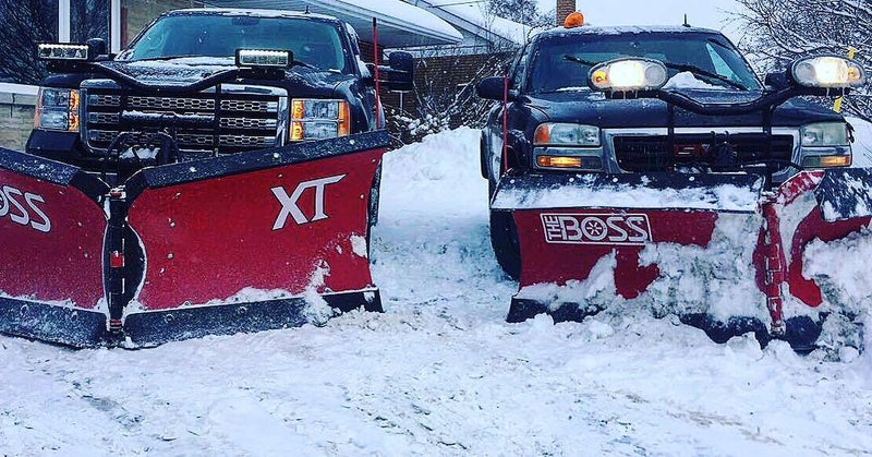 Tractor plowing commercial parking lot in Sudbury